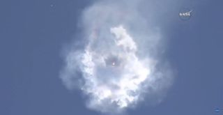 SpaceX's Falcon 9 rocket and Dragon cargo spacecraft broke up shortly after liftoff on June 28. The craft disappeared behind a cloud of smoke and left behind bits of falling debris.
