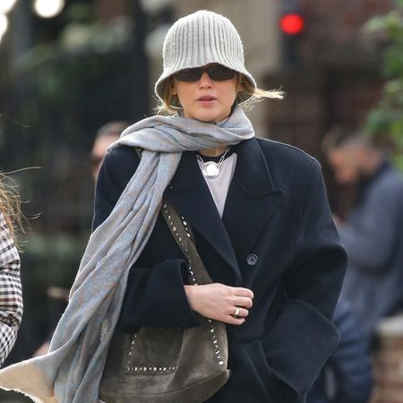 Jennifer Lawrence wearing a gray scarf and bucket hat
