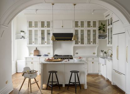 white kitchen with timeless style and black bar stools