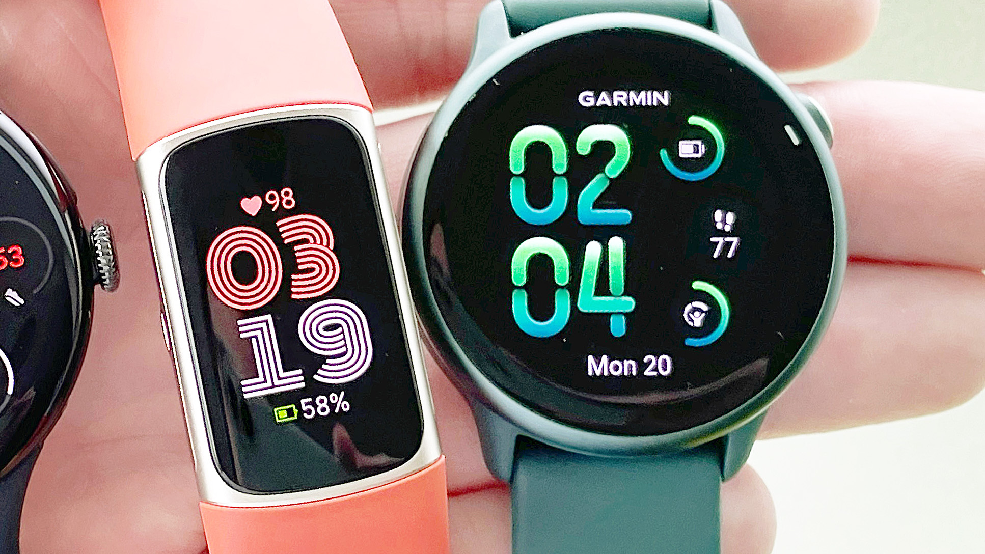 Close-up of Garmin Vivoactive 6 and Fitbit Charge 6