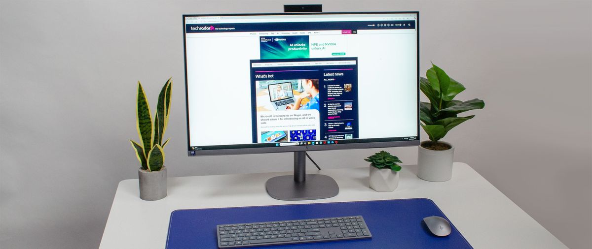 HP OmniStudio X 31.5 all-in-one PC on a desk in front of its bundled keyboard and mouse