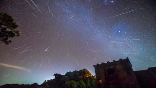 Dozens of meteors from the Geminids fill the night sky. 