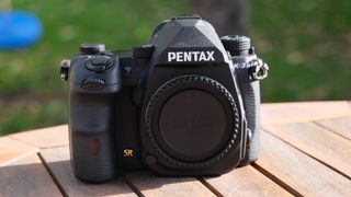 The Pentax K-3 III DSLR, showing the front of the camera without a lens on