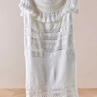 Crochet Throw Blanket against a beige background.
