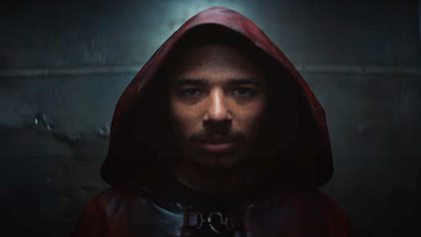 Anthony Ramos' The Hood smiling in the shadows in Ironheart