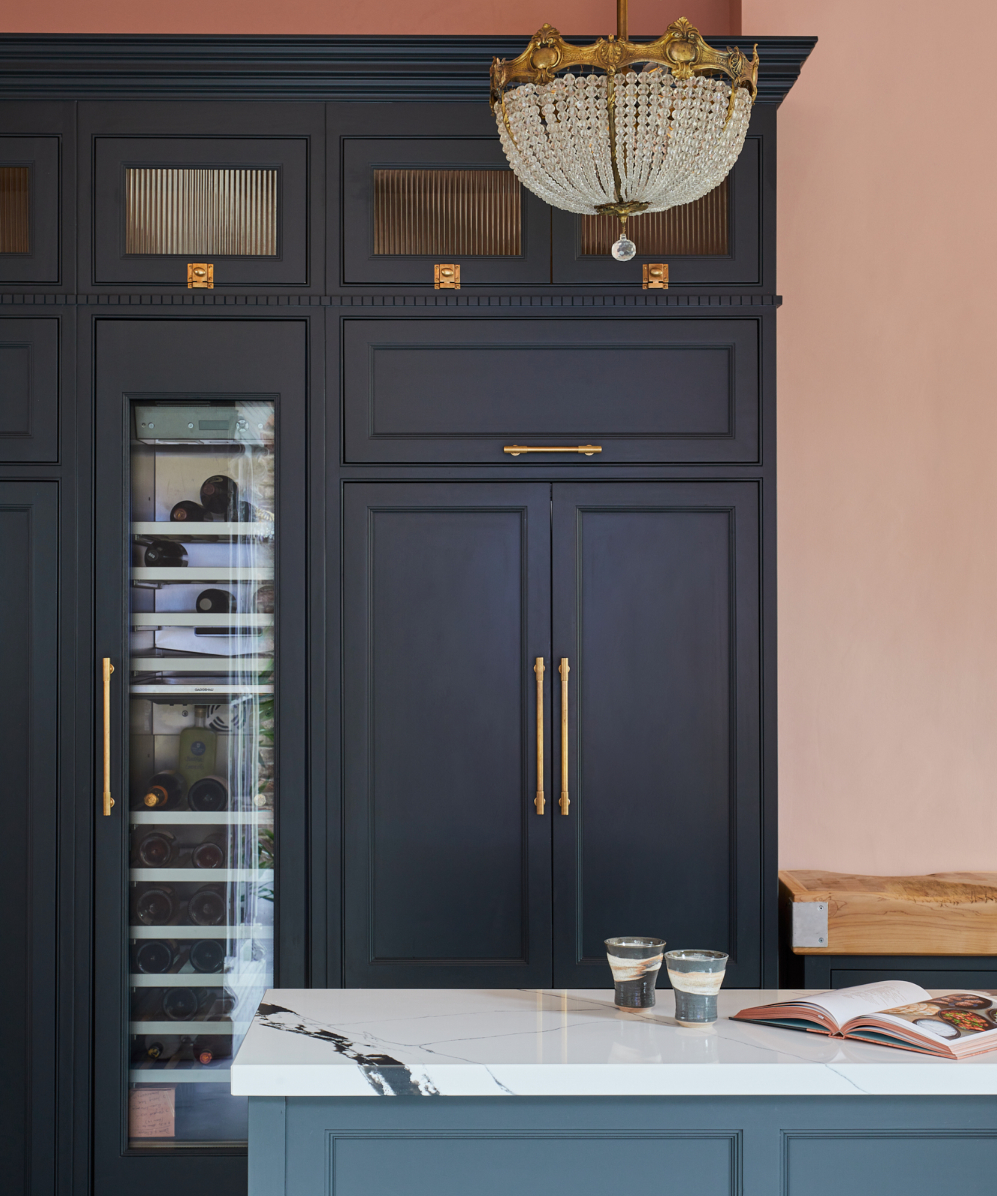 Navy kitchen with pink walls and wine fridge