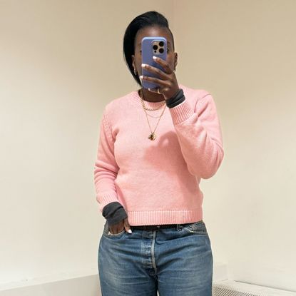 Nikki Ogunnaike wearing a pink sweater and jeans