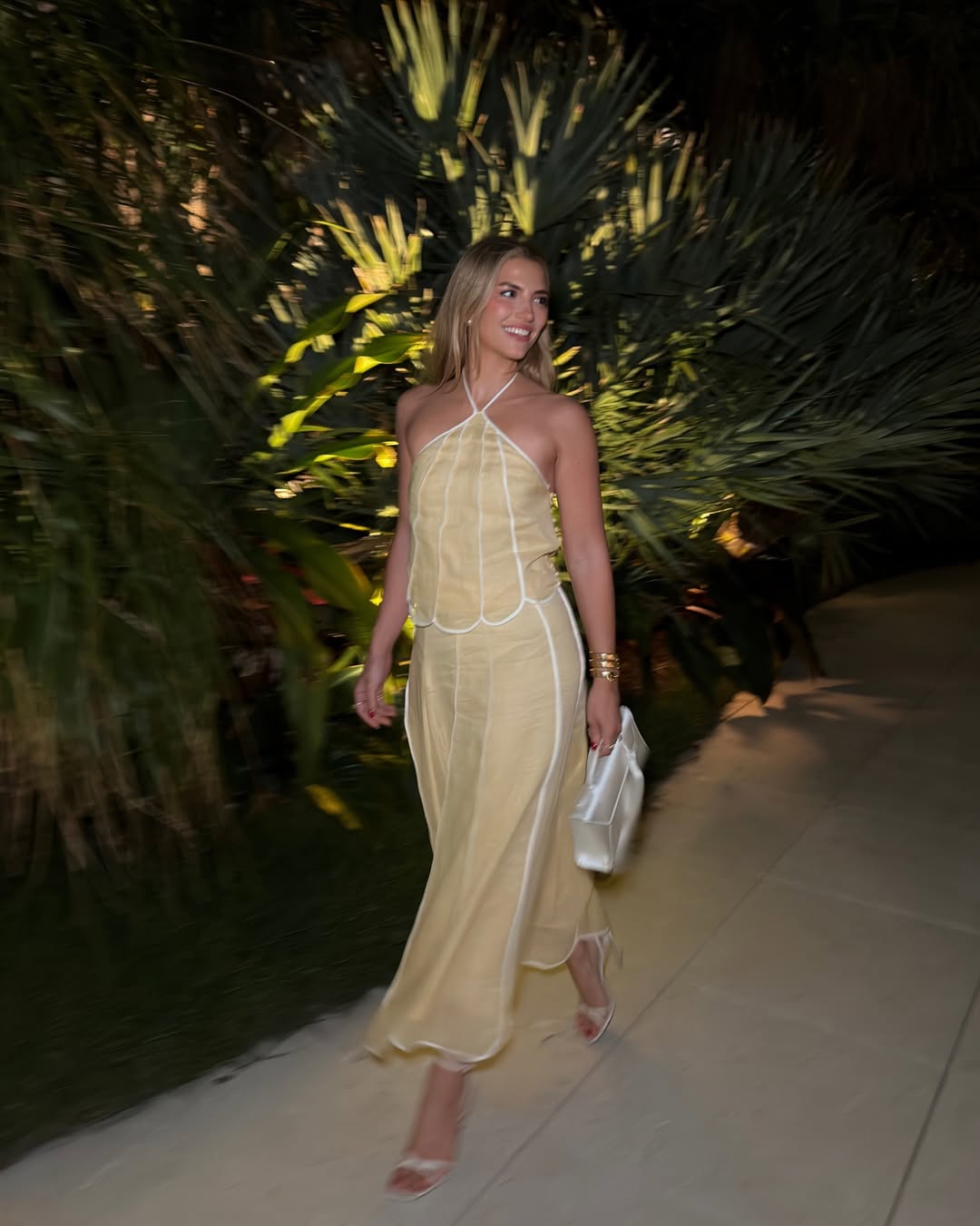Influencer Cass Dimicco wearing a linen co-ord, heeled sandals and top handle bag.