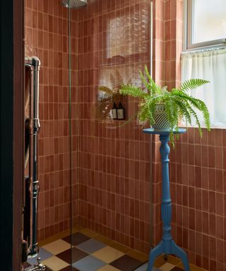 a tiled bathroom in a warm colors with pops of blue decor