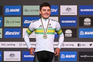 Second-placed Australias Hamish McKenzie celebrates on the podium after the mens junior individual time trial cycling event at the UCI 2022 Road World Championship in Wollongong on September 20 2022 IMAGE RESTRICTED TO EDITORIAL USE STRICTLY NO COMMERCIAL USE Photo by WILLIAM WEST AFP IMAGE RESTRICTED TO EDITORIAL USE STRICTLY NO COMMERCIAL USE Photo by WILLIAM WESTAFP via Getty Images