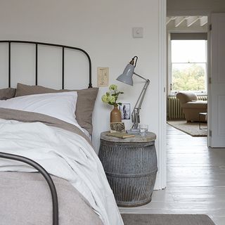 tonal grey bedroom with barrel table