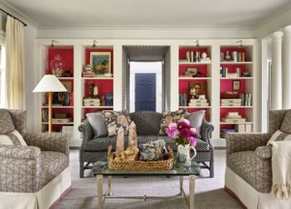 maximalist living room with red alcove shelving