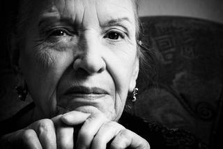 elderly woman in black-and-white photo.