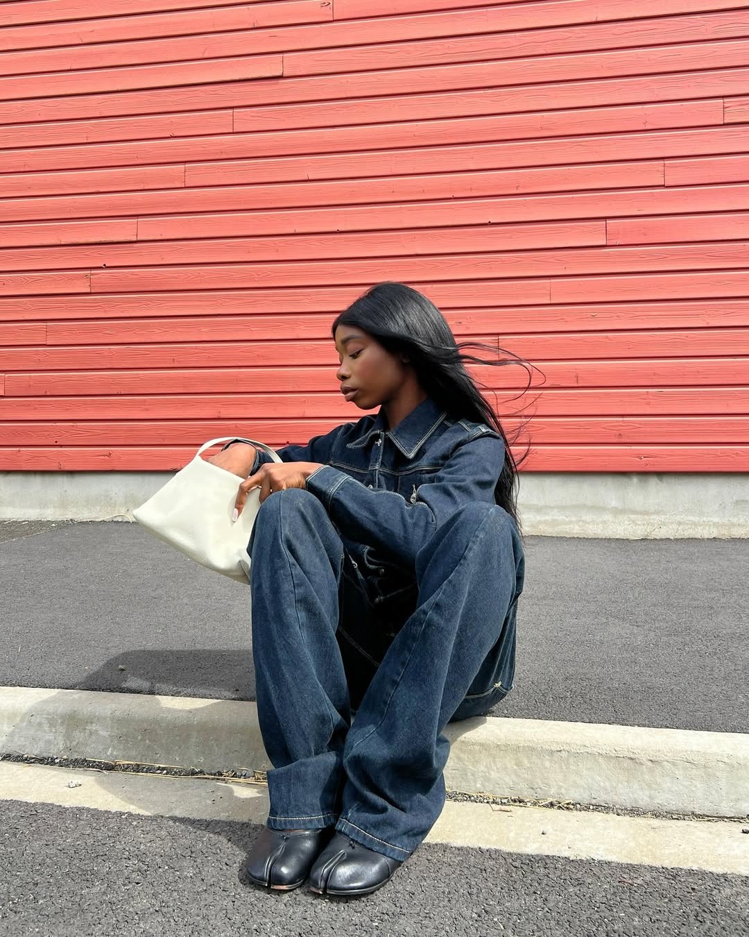 Aude Julie with dark-wash jeans with matching jacket and black Tabis.