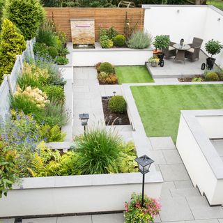 garden with patio areas and paving and a green lawn