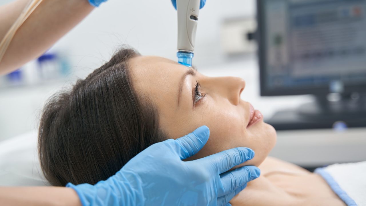 woman getting a hydrafacial in a spa