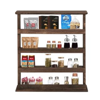 A brown wooden four-tiered kitchen shelf with bottles, sauces, and spices on it