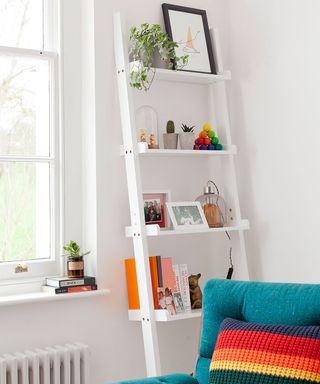 white living room with ladder shelf storage and sofa