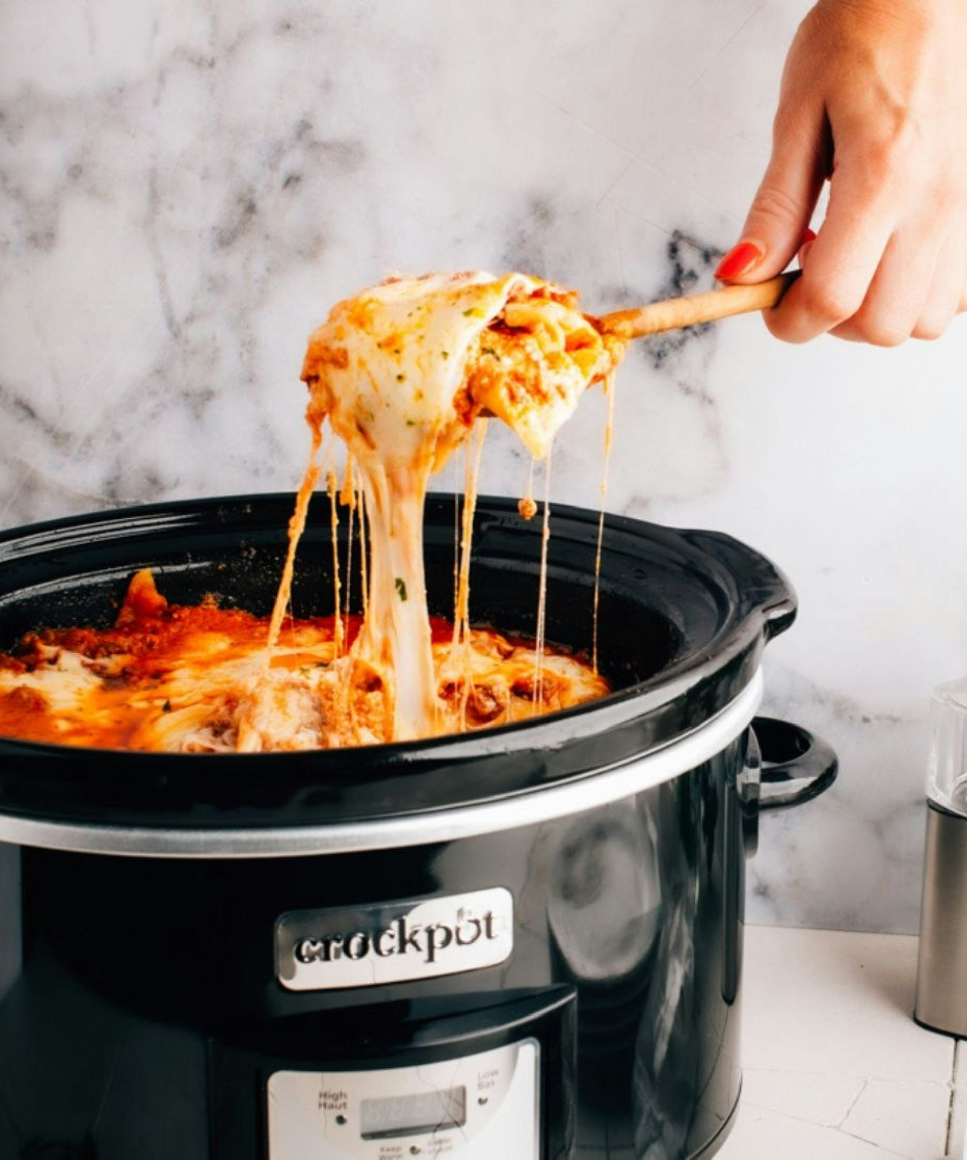Crock pot slow cooker on table with ingredients