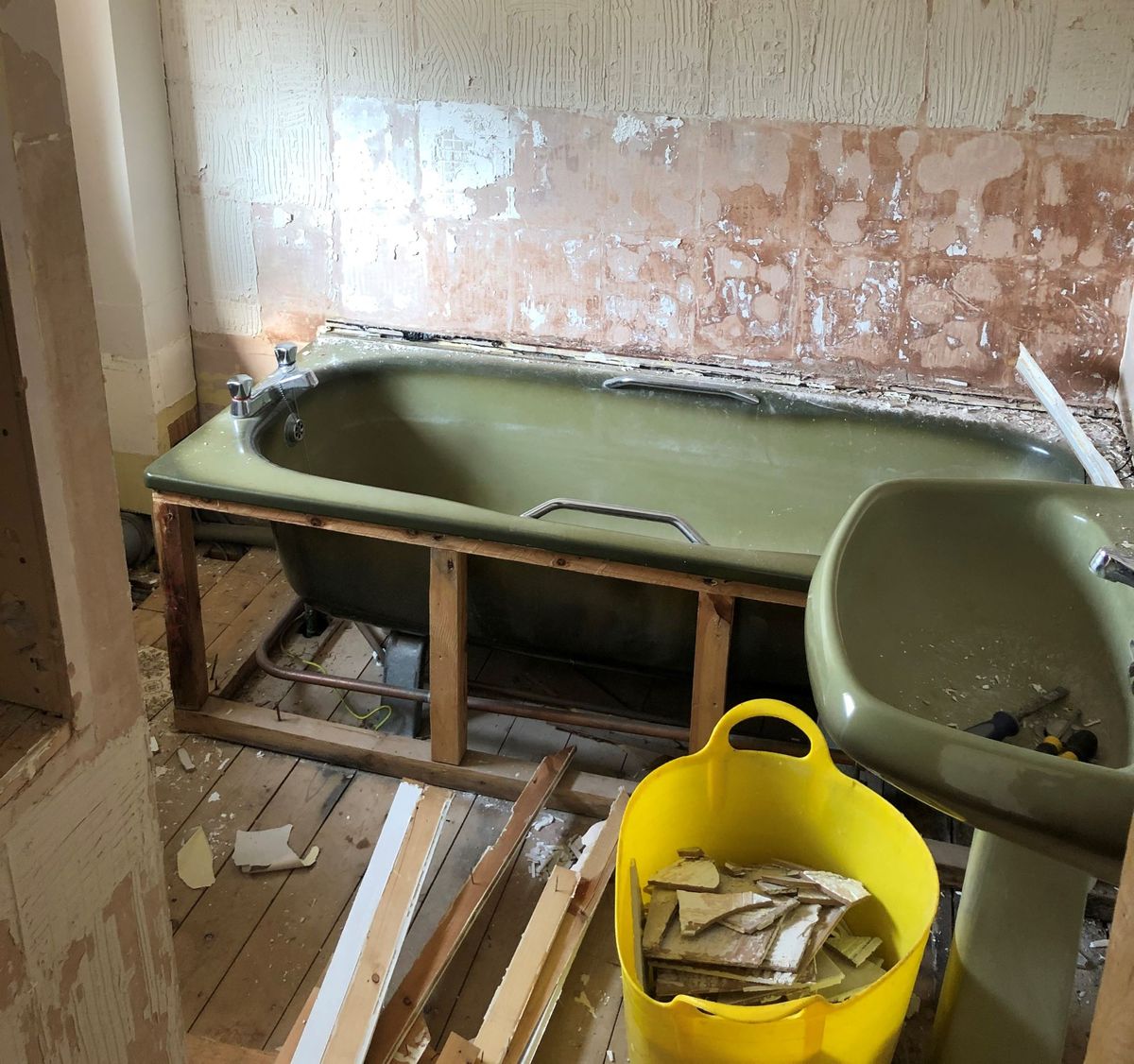 Avocado bathroom suite being ripped out