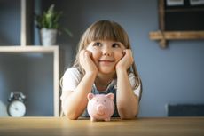 Young girl with piggy bank