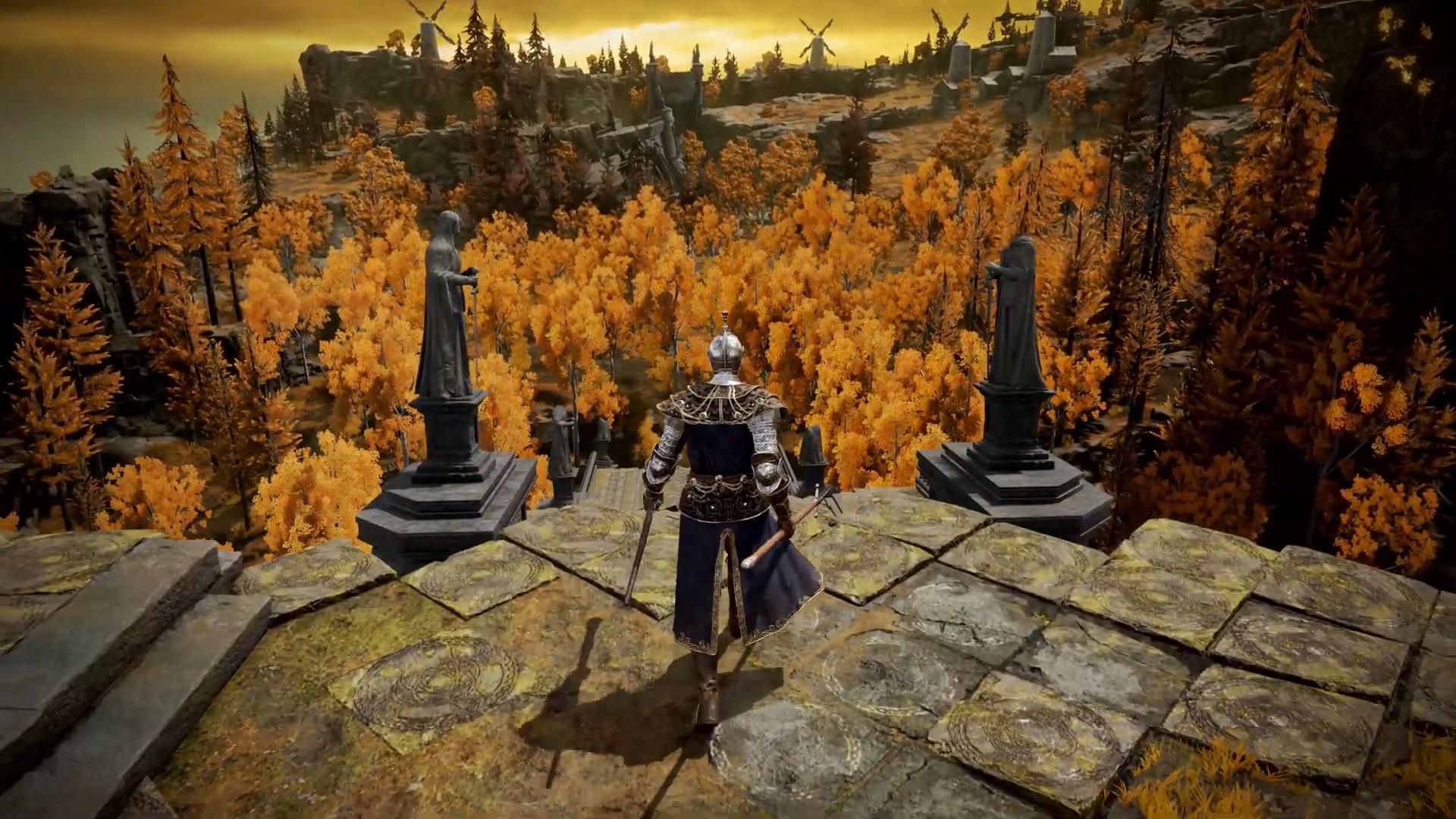 Elden Ring gameplay preview video - A player walks up to the edge of a ruin, looking down on a forest of bright orange trees.