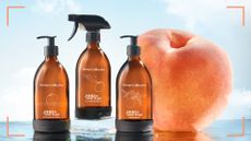 Bower Collective James And The Giant Peach Collection, showing the cleaning spray, hand washing and cleaning liquid on a liquid surface, next to a peach