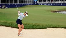 Nelly Korda hits out of a fairway bunker