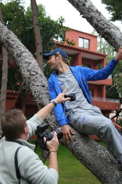 Tarzan Tom gets heckled by his teammates from their hotel rooms above.