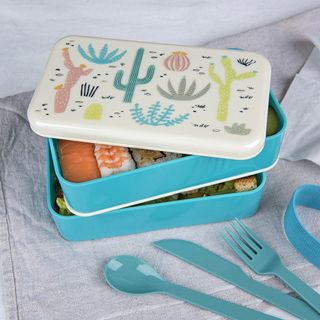 lunch box with grey background and spoon and fork