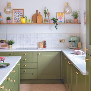 Green shaker kitchen with open shelving and white worktops