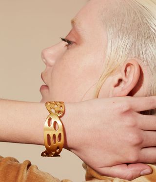 Motley gold bracelet worn on a model