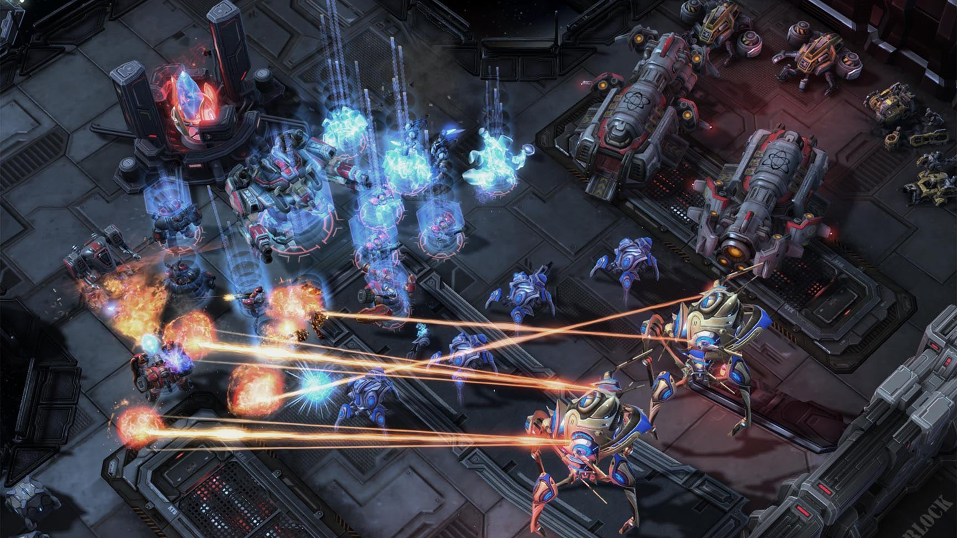Still from the video game StarCraft 2. Two large, technologically advanced vehicles are firing lasers at their human-like enemies in bulky space armor.