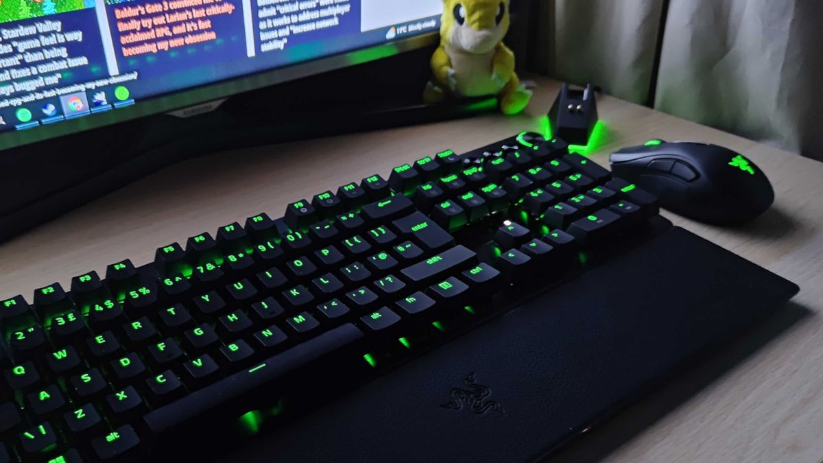 Razer Hunstman V3 Pro on a desk beside a mouse, monitor, Sandshrew plushie, and mouse dock