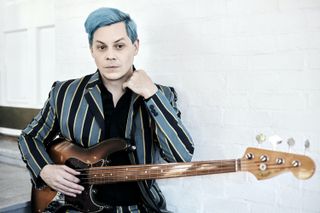 Jack White posing with his guitar.