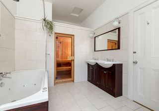 bathroom with bathtub and white tiles and floor and washbasin