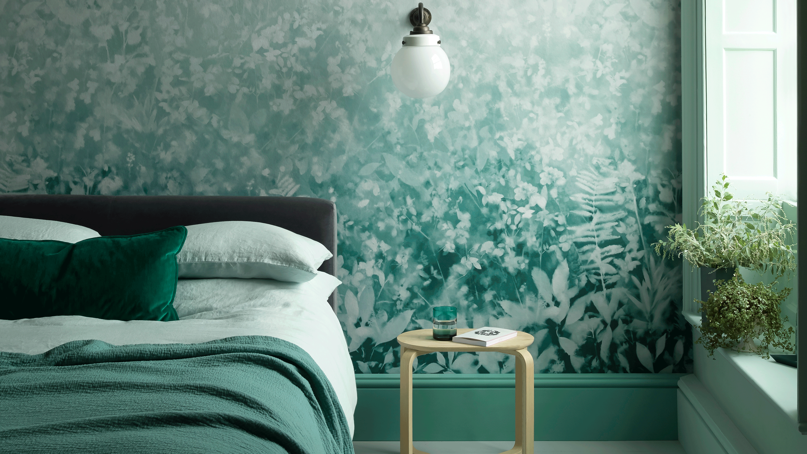 Teal bedroom with teal patterned wallpaper