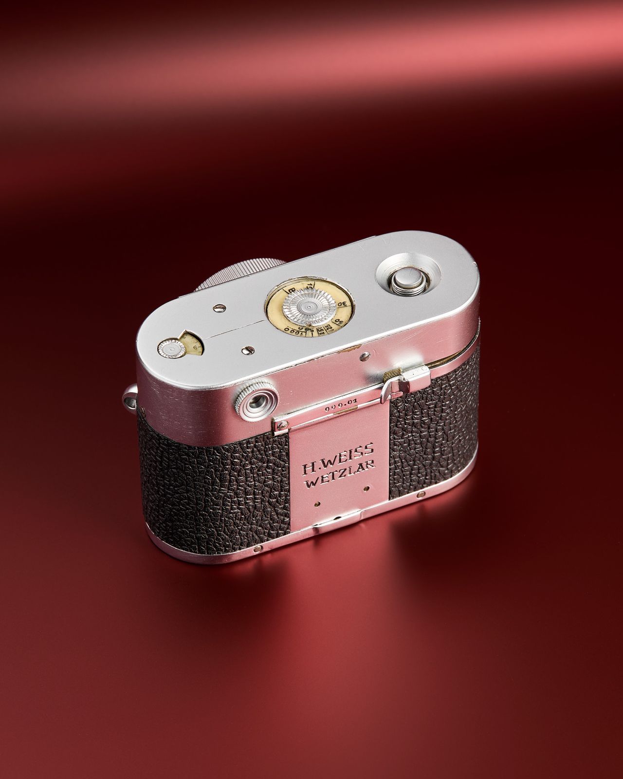 The working Leica Box camera prototype from the mid 1950s on a red background