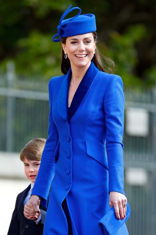 Kate, Princess of Wales, arrives at St George's Chapel in a blue Catherine Walker dress suit with Prince Louis for the Mattins Easter service