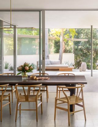 A bright, airy dining room with a wooden dining set