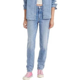 Levi's Women's 80s Mom Jeans on a model teamed with pink trainers 