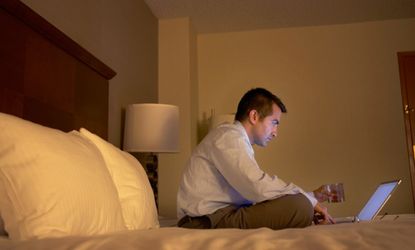 Man on laptop with drink