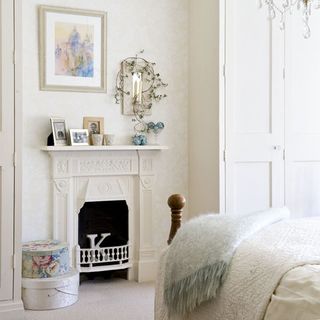 bedroom with cream walls and fireplace