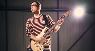 Cory Wong plays his new gold Ernie Ball Music Man signature StingRay II and wears a striped longsleeve
