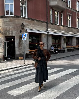 @monamali_ wearing cowboy boots and a black skirt