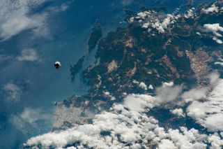 SpaceX's Crew Dragon spacecraft approaches the International Space Station with NASA astronauts Bob Behnken and Doug Hurley in this photo captured by an astronaut on board the orbiting lab on May 31, shortly before the spacecraft docked with the station. When the image was taken, the space station was orbiting above southwestern Turkey, including the coastal city of Demre, seen here as a grey area below the Crew Dragon.