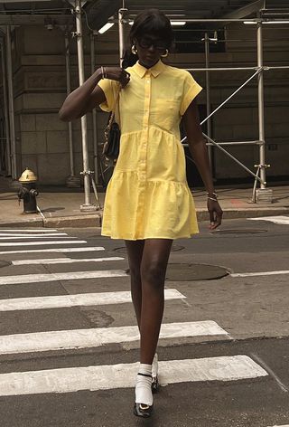 a woman's shirtdress outfit with a yellow dress with socks and Mary Janes