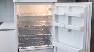 Fridge shelves covered in aluminum foil