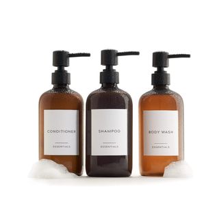 Three brown soap dispenser bottles with white labels