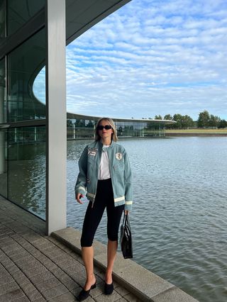 Eliza Huber wearing a denim Levi's x McLaren jacket with a white Levi's T-shirt and black capri pants at the McLaren Technology Center.